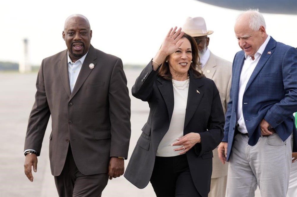 Democratic presidential nominee Vice President Kamala Harris and Democratic vice presidential candidate Minnesota Gov. Tim Walz walk with Savannah Mayor Van Johnson at the Savannah/Hilton Head International Airport in Savannah, Ga., as they arrive for campaign events, Wednesday, Aug. 28, 2024. (AP Photo/Jacquelyn Martin)