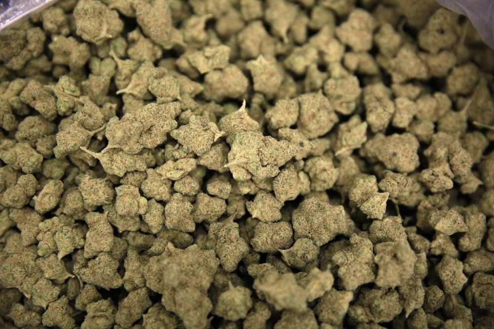 In this June 28, 2017, photo, a finished marijuana product fills a bag at the Desert Grown Farms cultivation facility in Las Vegas. Cannabis retailer Tokyo Smoke says it will be shuttering 29 of its stores as it seeks creditor protection THE CANADIAN PRESS/AP-John Locher