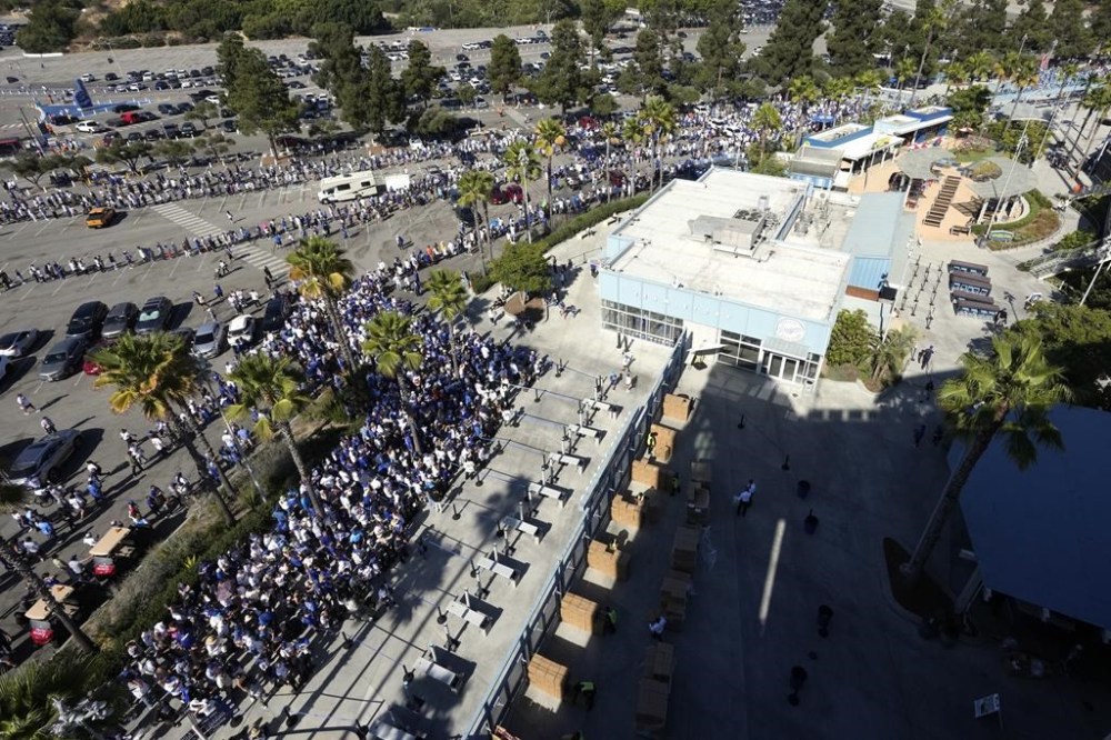 Fans line up to enter and get a bobblehead of Los Angeles Dodgers' Shohei Ohtani prior to a baseball game between the Dodgers and the Baltimore Orioles Thursday, Aug. 29, 2024, in Los Angeles. (AP Photo/Mark J. Terrill)