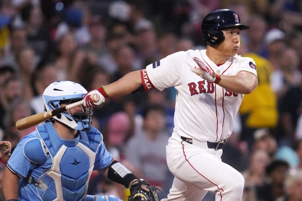 Boston Red Sox's Masataka Yoshida singles during the first inning of a baseball game against the Toronto Blue Jays at Fenway Park, Wednesday, Aug. 28, 2024, in Boston. (AP Photo/Charles Krupa)