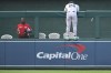 New York Yankees left fielder Alex Verdugo jumps onto the fence in an effort to catch Washington Nationals' Dylan Crews solo home run during the first inning of a baseball game, Wednesday, Aug. 28, 2024, in Washington. (AP Photo/John McDonnell)
