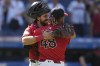 Cleveland Guardians catcher Austin Hedges, left, hugs relief pitcher Emmanuel Clase (48) after the Guardians defeated the Kansas City Royals in a baseball game Wednesday, Aug. 28, 2024, in Cleveland. (AP Photo/Sue Ogrocki)