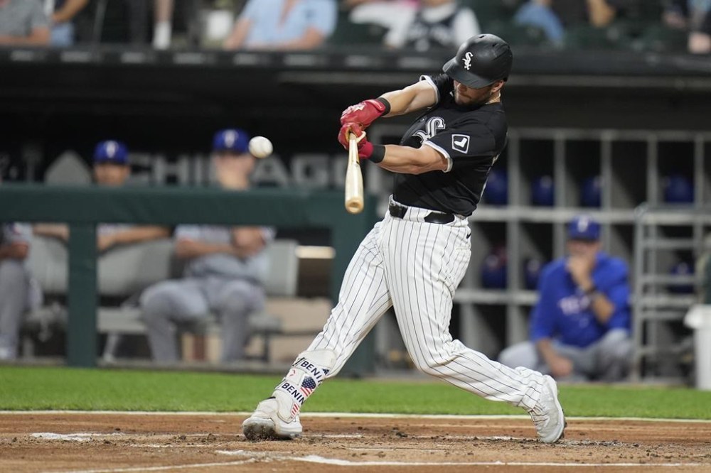 Chicago White Sox's Andrew Benintendi hits a two-run double during the first inning of the second game of a baseball double header against the Texas Rangers, Wednesday, Aug. 28, 2024, in Chicago. (AP Photo/Erin Hooley)