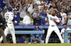 Los Angeles Dodgers' Shohei Ohtani, left, has sunflower seeds thrown at him by Teoscar Hernández after hitting a solo home run during the first inning of a baseball game against the Baltimore Orioles, Wednesday, Aug. 28, 2024, in Los Angeles. (AP Photo/Mark J. Terrill)