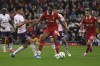 Liverpool's Ryan Gravenberch, centre, challenges for the ball with Brentford's Christian Norgaard during the English Premier League soccer match between Liverpool and Brentford at Anfield Stadium, Liverpool, England, Sunday, Aug. 25, 2024. (AP Photo/Rui Vieira)