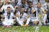 Real Madrid's Eder Militao, Kylian Mbappe, Vinicius Junior, and Luka Modric, from left, pose with the trophy after winning the UEFA Super Cup Final soccer match between Real Madrid and Atalanta at the Narodowy stadium in Warsaw, Poland, Wednesday, Aug. 14, 2024. Real Madrid won 2-0. (AP Photo/Darko Bandic)