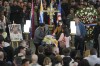 Family members of soccer player Juan Izquierdo stand by his coffin during a wake at his Nacional soccer club in Montevideo, Uruguay, Thursday, Aug. 29, 2024. Izquierdo died at a Brazilian hospital after collapsing on Aug. 22 during a Copa Libertadores soccer match between Nacional and Sao Paulo. (AP Photo/Matilde Campodonico)