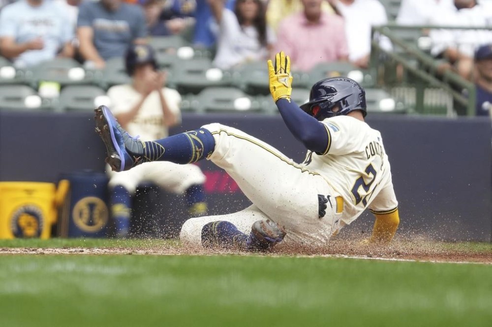 Milwaukee Brewers' William Contreras steals home during the third inning of a baseball game against the San Francisco Giants, Thursday, Aug. 29, 2024, in Milwaukee. (AP Photo/Kenny Yoo)