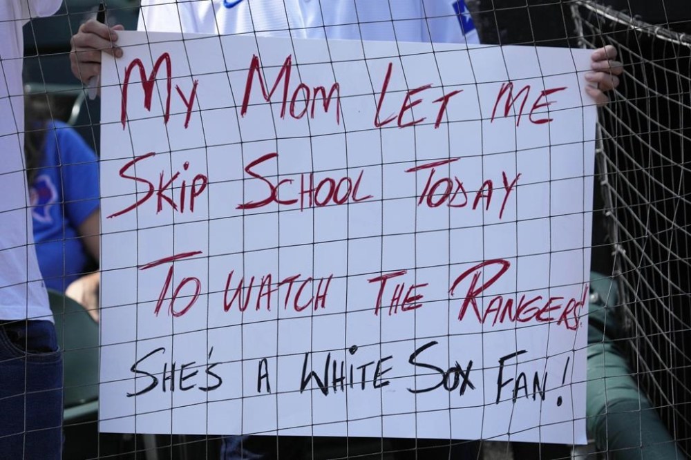 A fan holds a sign before a baseball game between the Texas Rangers and the Chicago White Sox in Chicago, Thursday, Aug. 29, 2024. (AP Photo/Nam Y. Huh)