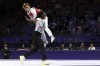 Zakia Khudadadi from the Paralympic Refugee Team, top, celebrates her bronze medal in Para Taekwondo during the Paralympic Games in Paris, Thursday, Aug. 29, 2024. (AP Photo/Madeleine Mertens)