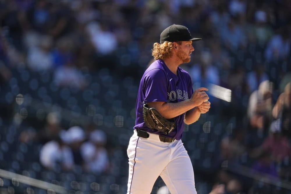 Colorado Rockies relief pitcher Noah Davis rubs a new ball after giving up a two-run home run to Miami Marlins' Derek Hill in the sixth inning of a baseball game Thursday, Aug. 29, 2024, in Denver. (AP Photo/David Zalubowski)