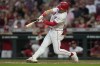 Cincinnati Reds' TJ Friedl hits a single on a ground ball to right field, driving in Jonathan India and Elly De La Cruz during the ninth inning of a baseball game against the Oakland Athletics, Thursday, Aug. 29, 2024, in Cincinnati. (AP Photo/Carolyn Kaster)