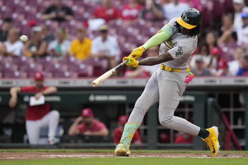 Oakland Athletics' Lawrence Butler hits a two-run homer in the second inning of a baseball game against the Cincinnati Reds, Thursday, Aug. 29, 2024, in Cincinnati. (AP Photo/Carolyn Kaster)