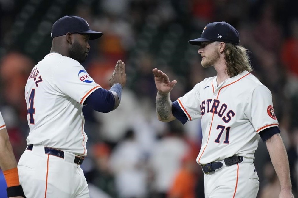Houston Astros designated hitter Yordan Alvarez, left, and closer Josh Hader (71) high-five after a baseball game against the Kansas City Royals, Thursday, Aug. 29, 2024, in Houston. (AP Photo/Kevin M. Cox)