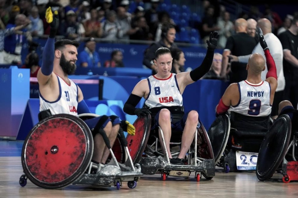 Clayton Brackets, left, and Sarah Adam from the United States acknowledge applauses after they defeated Canada 51-48 during the 2024 Paralympics Wheelchair Rugby match United States against Canada at the Champs Mars Arena Thursday, Aug. 29, 2024, in Paris, France. (AP Photo/Michel Euler)
