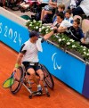 Israel's Adam Berdichevsky shakes hands with his wife Hila and his daughter during the 2024 Paralympics men's Wheelchair singles tennis tournament first round match against Italy's Luca Arca at Roland Garros Stadium in Paris, France, Friday Aug. 30, 2024. (AP Photo/Michel Euler)