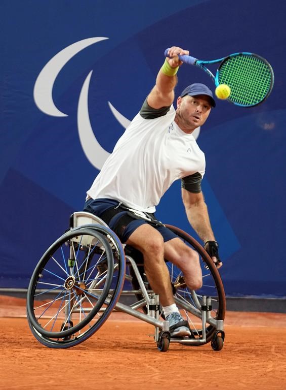 Israel's Adam Berdichevsky returns the ball to Italy's Luca Arca during their 2024 Paralympics men's Wheelchair singles tennis tournament first round match at Roland Garros Stadium in Paris, France, Friday Aug. 30, 2024. (AP Photo/Michel Euler)