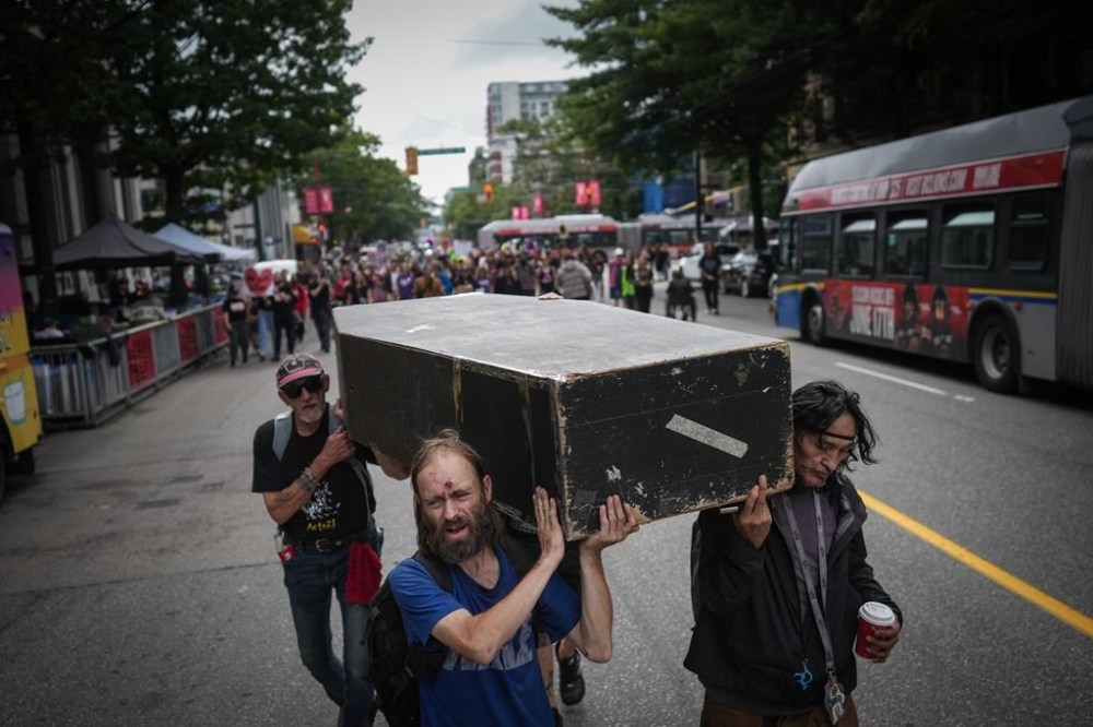 The British Columbia Coroners Service says about 192 people died in July in the province due to unregulated drug toxicity, down 15 per cent from the same month last year. Andrew Leavens, front left, and Carl Gladue, right, carry an empty coffin during a march organized by the Vancouver Area Network of Drug Users (VANDU) to mark International Overdose Awareness Day, in Vancouver, B.C., Thursday, Aug. 31, 2023. THE CANADIAN PRESS/Darryl Dyck