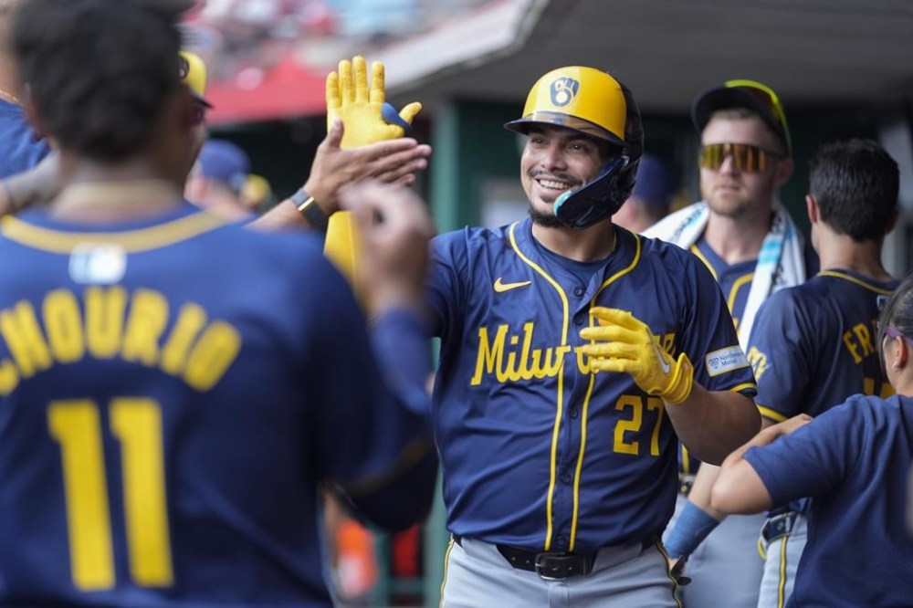 Milwaukee Brewers' Willy Adames (27) celebrates hitting a home run during the second inning of a baseball game against the Cincinnati Reds, Friday, Aug. 30, 2024, in Cincinnati. (AP Photo/Carolyn Kaster)