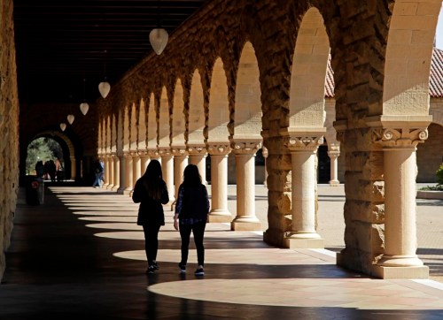 FILE - Students walk on the Stanford University campus on March 14, 2019, in Stanford, Calif. (AP Photo/Ben Margot, File)
