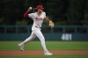 Philadelphia Phillies third base Alec Bohm throws to first after fielding a ground out by Houston Astros' Jeremy Peña during the first inning of a baseball game, Monday, Aug. 26, 2024, in Philadelphia. (AP Photo/Matt Slocum)
