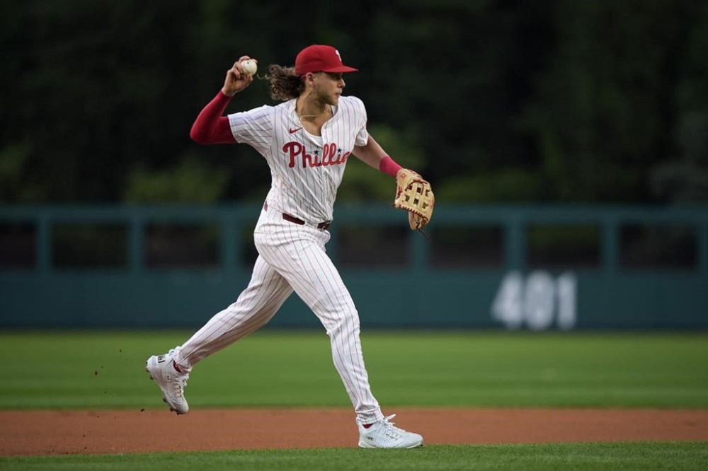 Philadelphia Phillies third base Alec Bohm throws to first after fielding a ground out by Houston Astros' Jeremy Peña during the first inning of a baseball game, Monday, Aug. 26, 2024, in Philadelphia. (AP Photo/Matt Slocum)