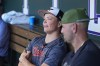 Retired Major League Baseball player Matt Holliday, front, listens as his son, Jackson, second baseman for the Baltimore Orioles, talks to reporters before the Orioles face the Colorado Rockies in a baseball game Friday, Aug. 30, 2024, in Denver. (AP Photo/David Zalubowski)