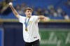 2024 Olympic swimming gold and silver medalist Bobby Finke throws out the ceremonial first pitch before a baseball game between the Tampa Bay Rays and the San Diego Padres Friday, Aug. 30, 2024, in St. Petersburg, Fla. (AP Photo/Chris O'Meara)