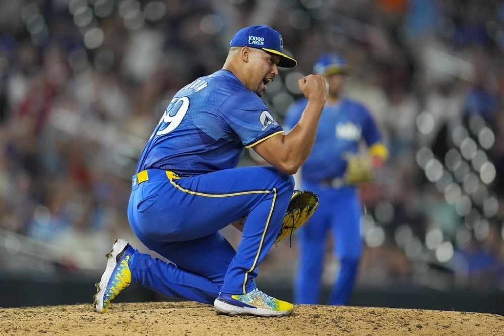 Minnesota Twins relief pitcher Jhoan Duran (59) celebrates after forcing the final out to defeat the Toronto Blue Jays 2-0 of a baseball game Friday, Aug. 30, 2024, in Minneapolis. (AP Photo/Abbie Parr)