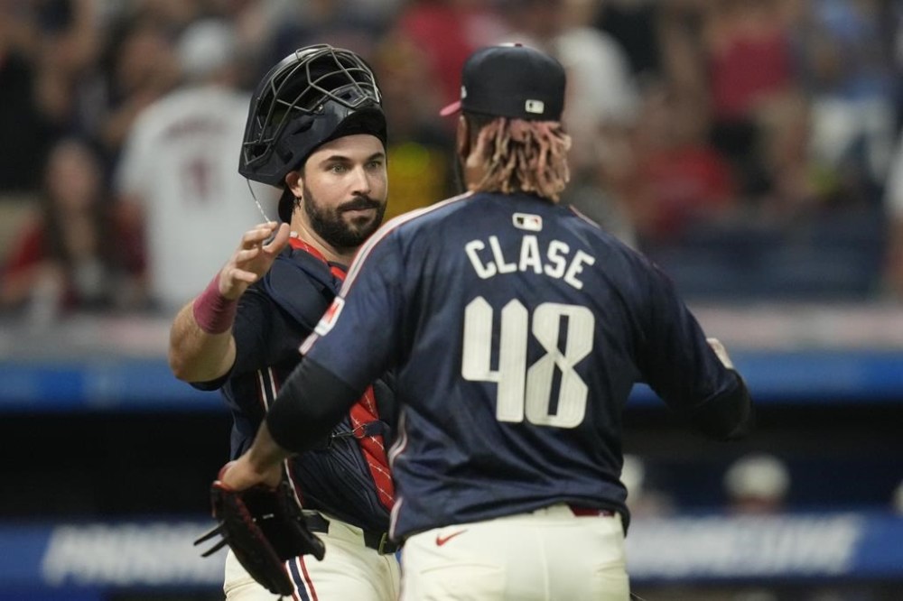 Cleveland Guardians catcher Austin Hedges, left, congratulates relief pitcher Emmanuel Clase (48) after they defeated the Pittsburgh Pirates in a baseball game Friday, Aug. 30, 2024, in Cleveland. (AP Photo/Sue Ogrocki)