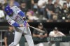 New York Mets' J.D. Martinez hits a two-run home run off Chicago White Sox pitcher Jonathan Cannon, also scoring Jesse Winker, during the third inning of a baseball game Friday, Aug. 30, 2024, in Chicago. (AP Photo/Charles Rex Arbogast)