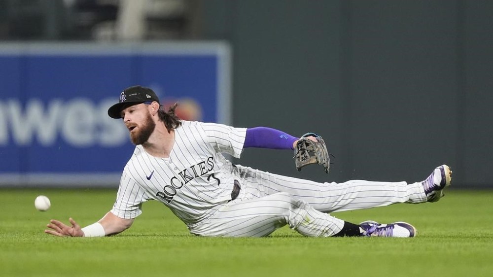 Colorado Rockies second baseman Brendan Rodgers misses a single off the bat of Baltimore Orioles' Ramón Urías in the sixth inning of a baseball game Friday, Aug. 30, 2024, in Denver. (AP Photo/David Zalubowski)