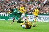 Dortmund's Nico Schlotterbeck, bottom right, fouls Werder's Justin Njinmah during the German Bundesliga soccer match between Werder Bremen and Borussia Dortmund in Bremen, Germany, Saturday, Aug. 31, 2024. (Carmen Jaspersen/dpa via AP)
