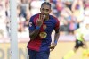 Barcelona's Raphinha celebrates scoring his side's 5th goal during the Spanish La Liga soccer match between FC Barcelona and Valladolid at the Olympic stadium in Barcelona, Spain, Saturday, Aug. 31, 2024. (AP Photo/Joan Monfort)