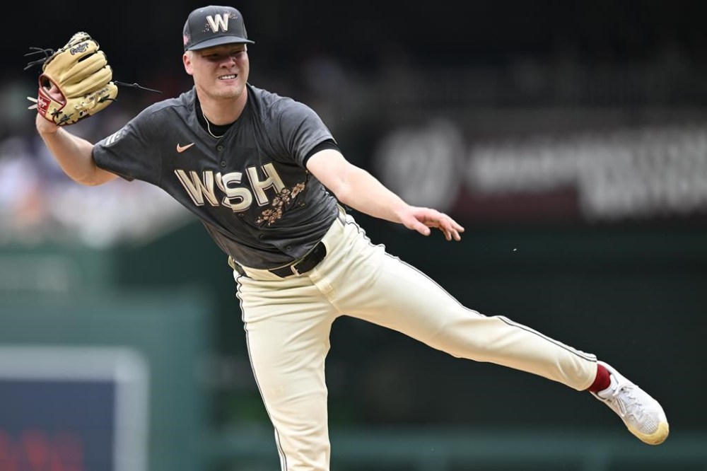 Washington Nationals starting pitcher DJ Herz follows through during the first inning of a baseball game against the Chicago Cubs, Saturday, Aug. 31, 2024, in Washington. (AP Photo/John McDonnell)