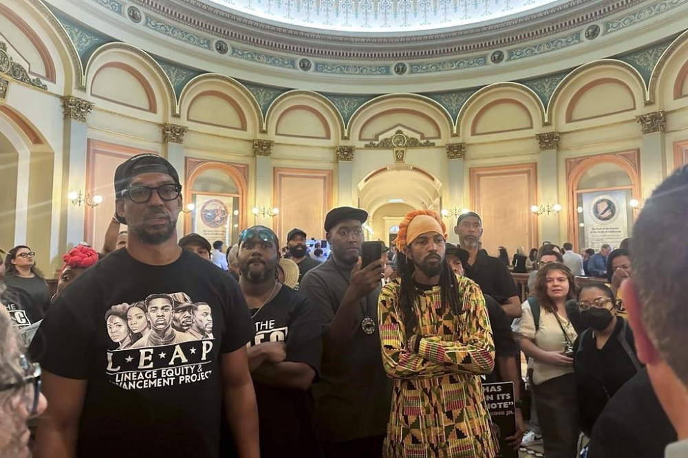 Members of Coalition for a Just and Equitable California protest and demand lawmakers to take up a vote on two reparations bill in the rotunda on the last day of the legislative year Saturday, Aug. 31, 2024, in Sacramento, Calif. (AP Photo/Tran Nguyen)