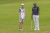 Sahith Theegala discusses strategy with his caddy from the 18th hole fairway during the third round of the Tour Championship golf tournament, Saturday, Aug. 31, 2024, in Atlanta. (AP Photo/Jason Allen)