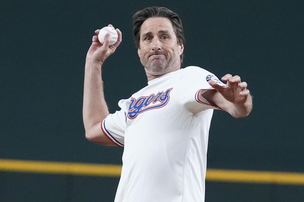 Actor Luke Wilson throws the ceremonial first pitch before a baseball game between the Oakland Athletics and Texas Rangers Saturday, Aug. 31, 2024, in Arlington, Texas. (AP Photo/LM Otero)