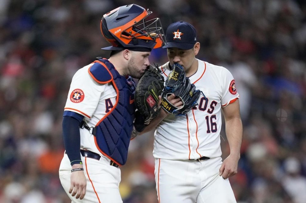 Houston Astros starting pitcher Yusei Kikuchi (16) talks to catcher Yainer Diaz during the sixth inning of a baseball game against the Kansas City Royals, Saturday, Aug. 31, 2024, in Houston. (AP Photo/Eric Christian Smith)