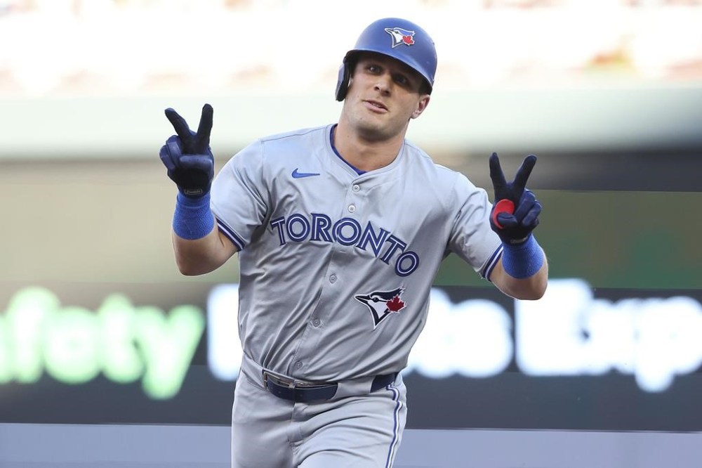 Toronto Blue Jays' Daulton Varsho celebrates his two-run home run while he runs the bases during the first inning of a baseball game against the Minnesota Twins, Saturday, Aug. 31, 2024, in Minneapolis. (AP Photo/Matt Krohn)
