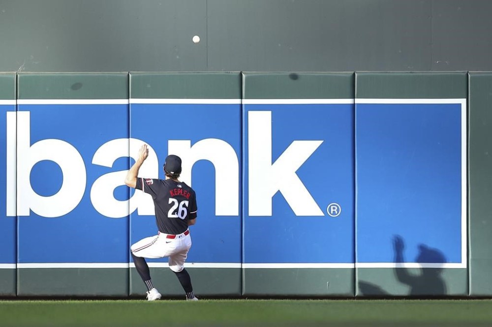Minnesota Twins right fielder Max Kepler attempts to field the ball hit by Toronto Blue Jays' Alejandro Kirk during the first inning of a baseball game, Saturday, Aug. 31, 2024, in Minneapolis. (AP Photo/Matt Krohn)