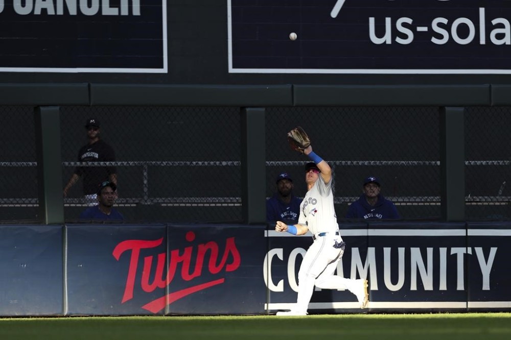 Toronto Blue Jays center fielder Daulton Varsho catches a fly ball hit by Minnesota Twins designated hitter Trevor Larnach during the first inning of a baseball game, Saturday, Aug. 31, 2024, in Minneapolis. (AP Photo/Matt Krohn)