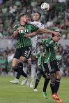 Austin FC defender Matt Hedges (2) and Vancouver Whitecaps defender Bjørn Inge Utvik (15) jump for a pass during the second half of an MLS soccer match in Austin, Texas, Saturday, Aug. 31, 2024. (AP Photo/Eric Gay)