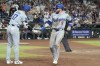 Los Angeles Dodgers' Gavin Lux (9) celebrates his run scored against against the Arizona Diamondbacks with Dodgers' Shohei Ohtani (17), of Japan, during the ninth inning of a baseball game Saturday, Aug. 31, 2024, in Phoenix. (AP Photo/Ross D. Franklin)