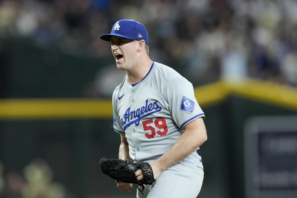 Los Angeles Dodgers relief pitcher Evan Phillips celebrates after the final out of a baseball game against the Arizona Diamondbacks, Saturday, Aug. 31, 2024, in Phoenix. (AP Photo/Ross D. Franklin)