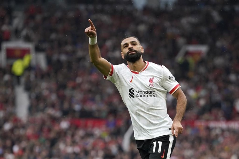 Liverpool's Mohamed Salah celebrates after scoring his side's third goal during the English Premier League soccer match between Manchester United and Liverpool at Old Trafford, Sunday, Sept. 1, 2024, in Manchester, England. (AP Photo/Dave Thompson)