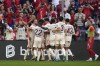 Bayern's Harry Kane, left, celebrates with teammates after scoring the opening goal during the Bundesliga soccer match between Bayern Munich and SC Freiburg at the Allianz Arena in Munich, Germany, Sunday, Sept. 1, 2024. (AP Photo/Matthias Schrader)