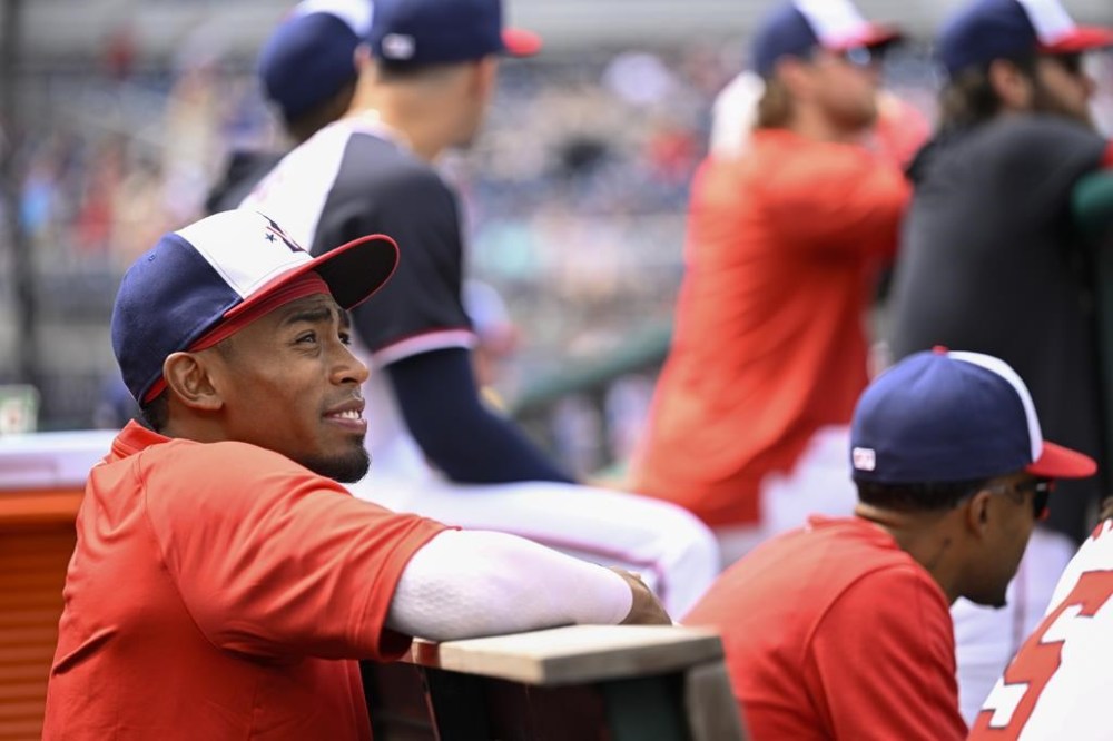 Washington Nationals' Darren Baker watches the action from the dugout during the first inning of a baseball game against the Chicago Cubs, Sunday, Sept. 1, 2024, in Washington. (AP Photo/John McDonnell)