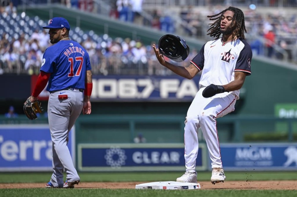 Washington Nationals' James Wood, right, holds up at third as Chicago Cubs third baseman Isaac Paredes (17) looks to left field where a double was hit during the second inning of a baseball game, Sunday, Sept. 1, 2024, in Washington. (AP Photo/John McDonnell)