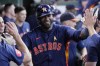 Houston Astros' Yordan Alvarez is congratulated in the dugout after hitting a solo home run during the sixth inning of a baseball game against the Kansas City Royals, Sunday, Sept. 1, 2024, in Houston. (AP Photo/Kevin M. Cox)